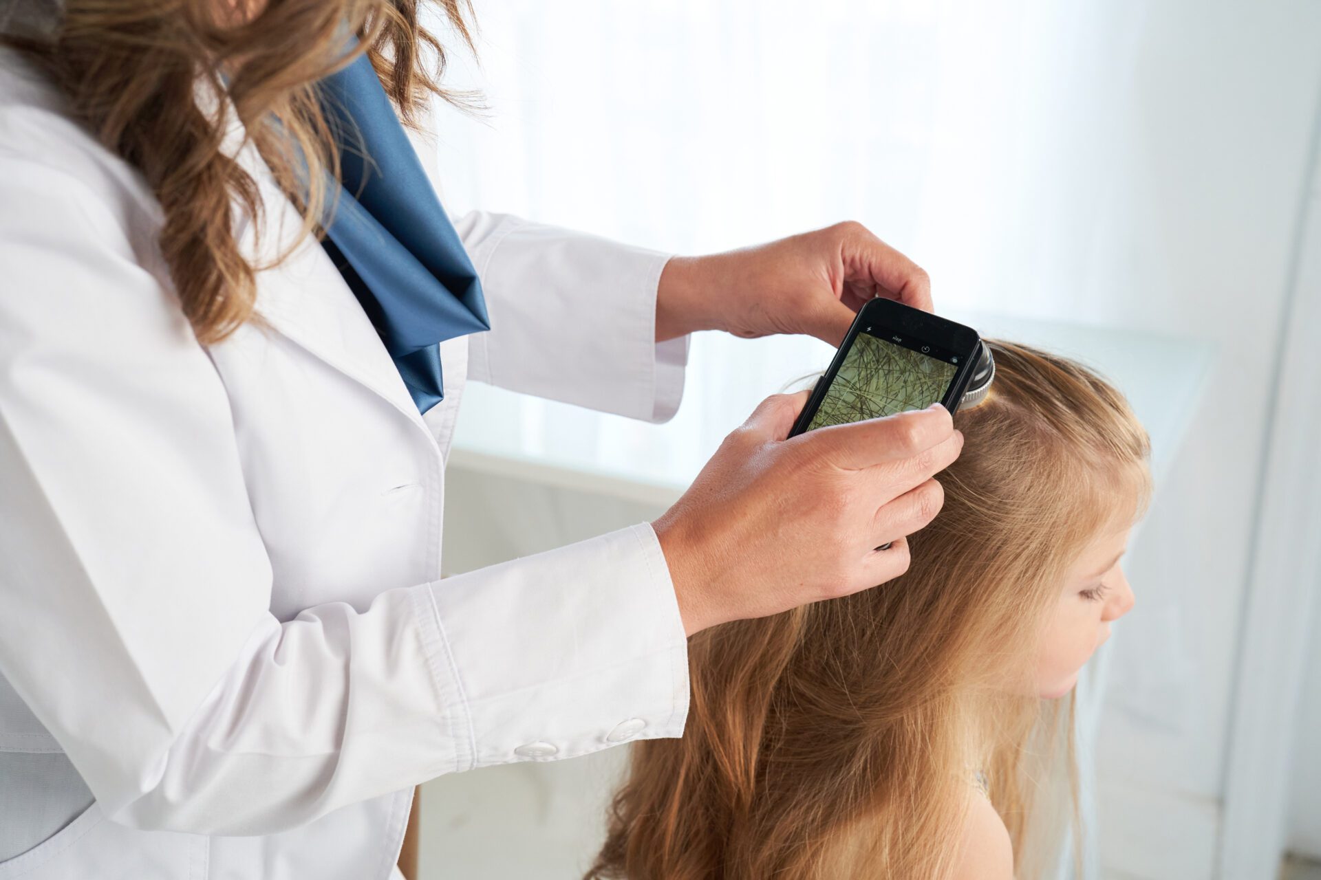 Doctor checking children hair